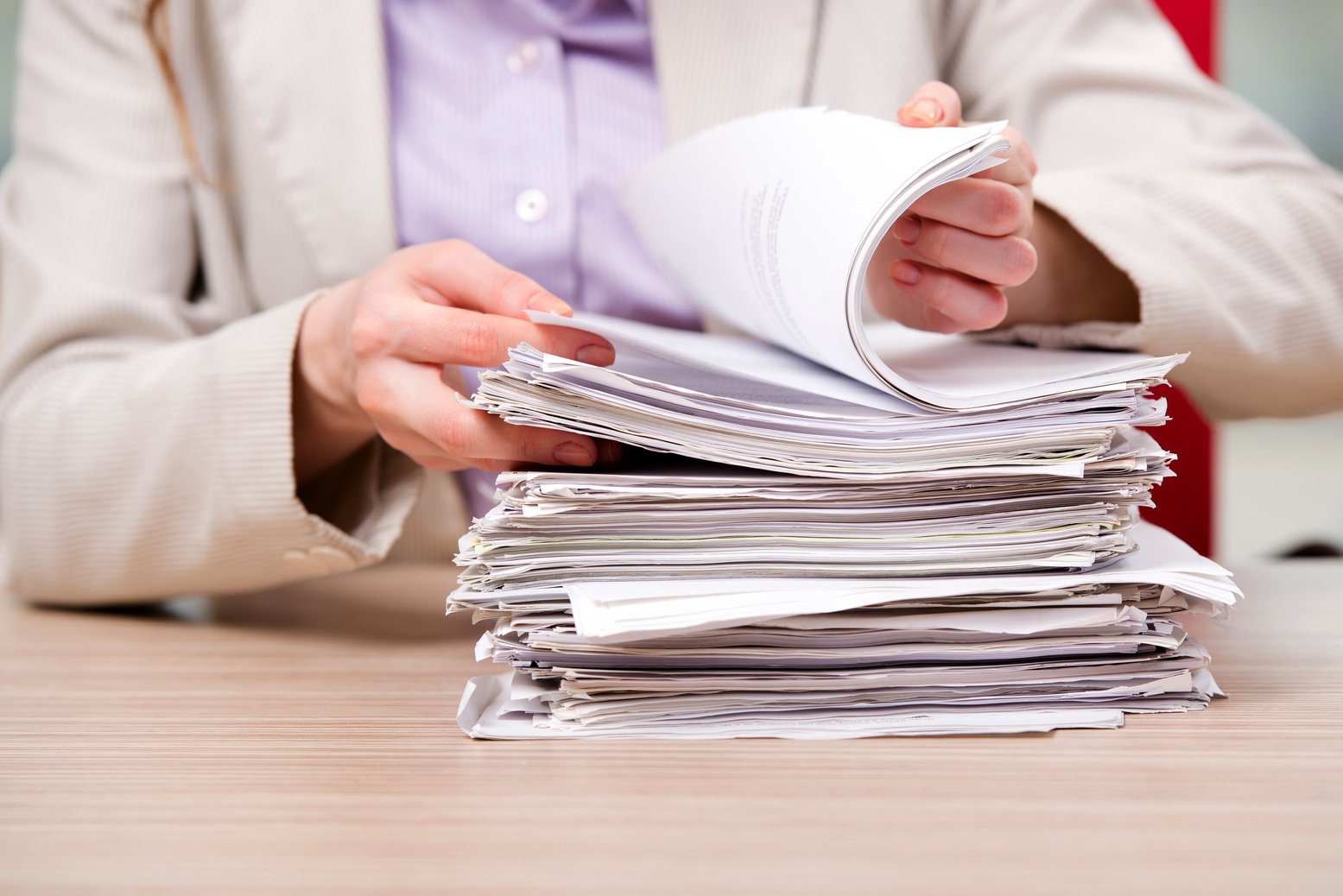 Businesswoman Working with Stack of Papers